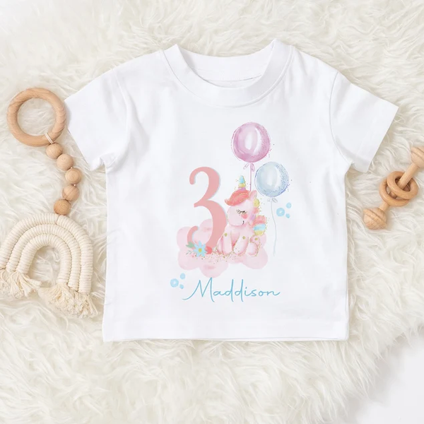 Whimsical unicorn girl's birthday t-shirt personalised with name and age